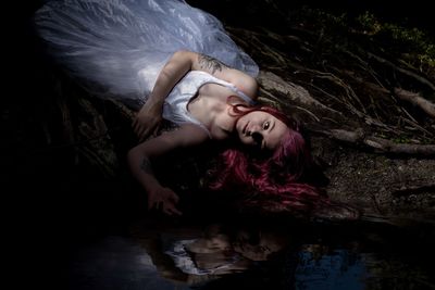 Portrait of woman lying in lake