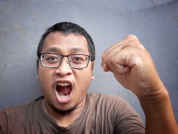 Portrait of man wearing mask against wall