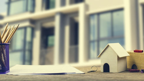 Close-up of books on table against building