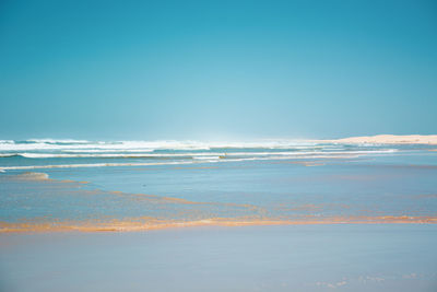 Scenic view of sea against clear blue sky