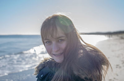 Portrait of woman against sea against sky