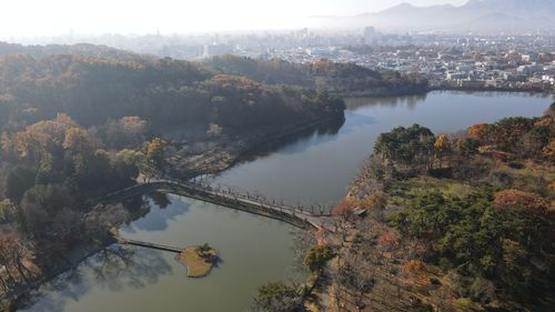 High angle view of river and trees in city