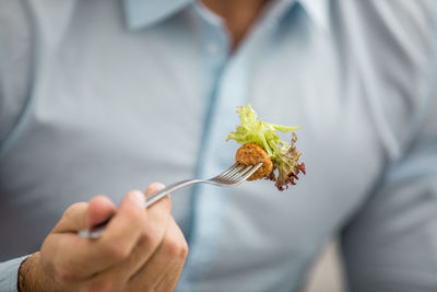 Midsection of woman holding flowering plant