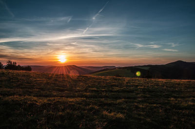 Scenic view of field against sky during sunset