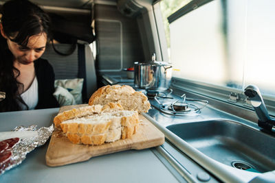 Midsection of woman preparing food in kitchen