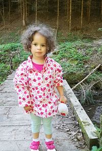 Portrait of cute girl standing outdoors