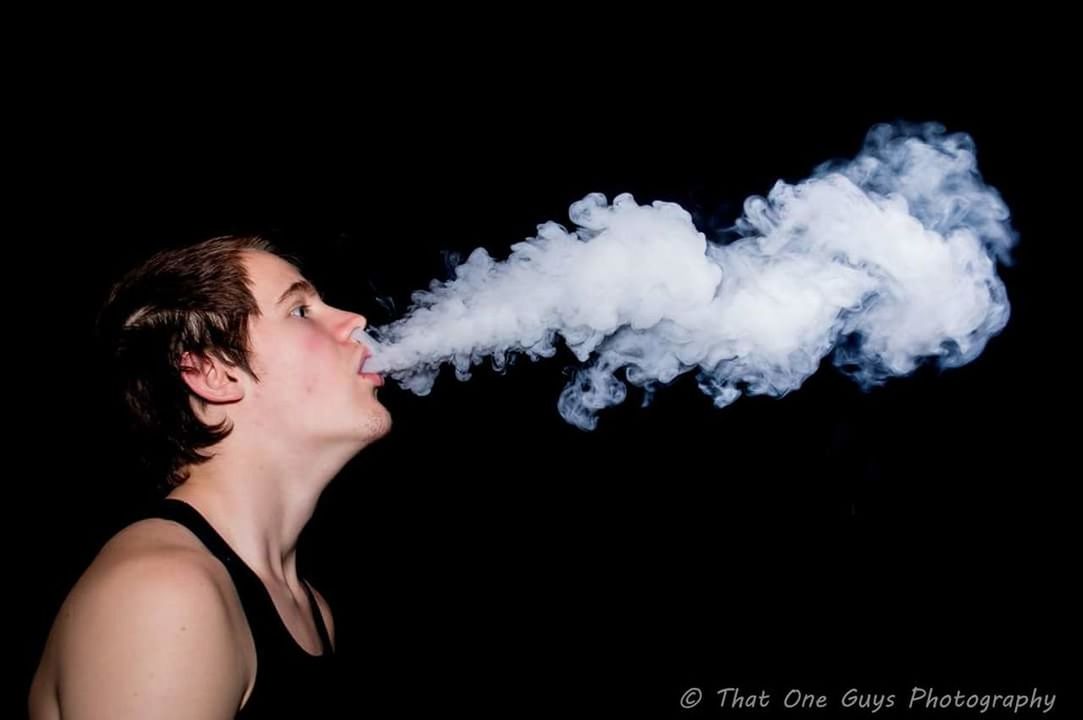 YOUNG WOMAN AGAINST BLACK BACKGROUND