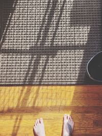 Low section of person on hardwood floor