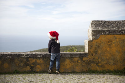 Child wearing santa hat looking away