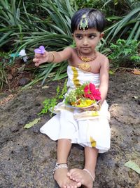 Portrait of happy girl holding flowers