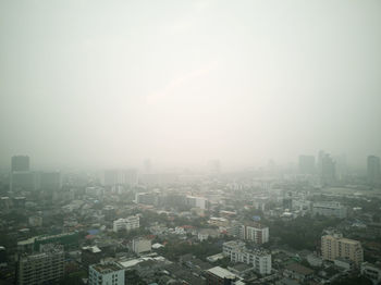 Aerial view of buildings in city against sky