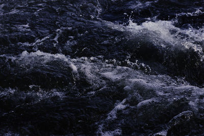 High angle view of water flowing through rocks