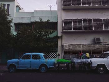 Cars parked on road against buildings in city