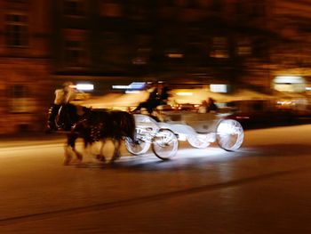 Blurred motion of illuminated car on street at night