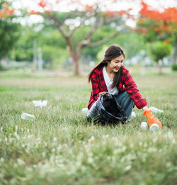 Young woman sitting on field