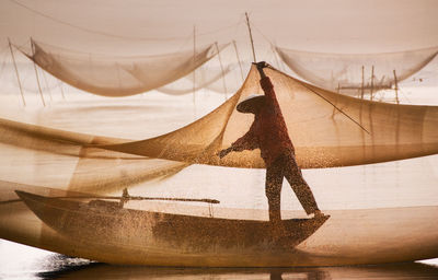 Midsection of woman standing in sea against sky