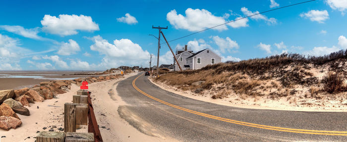 Blue sky over roadway along chapin beach in cape cod, massachusetts.