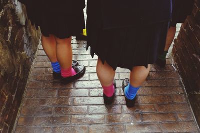 Woman standing on footpath