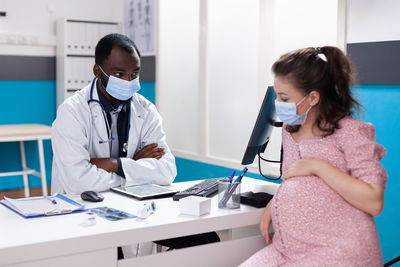 Female doctor examining patient at clinic