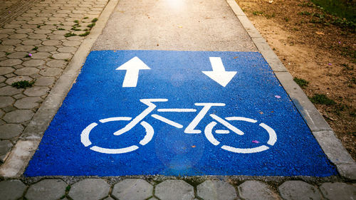 High angle view of arrow sign on road