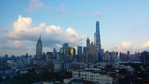 Cityscape against cloudy sky