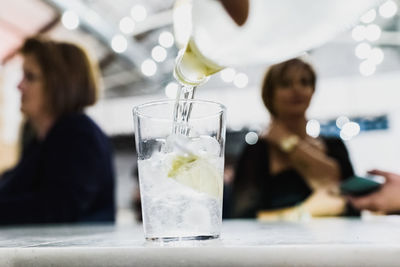 Woman drinking glass on table