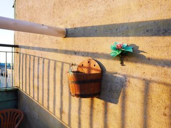 Wooden flower pot mounted on wall