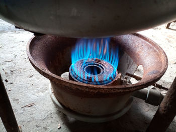 High angle view of burning candles on wood