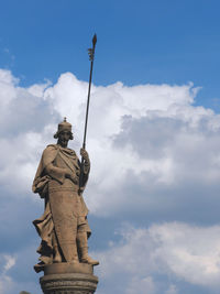 Low angle view of statue against cloudy sky