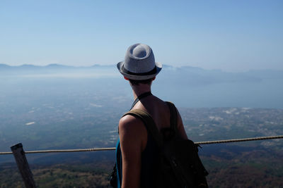 Woman standing on mountain against clear sky