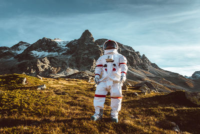 Man standing on mountain against sky