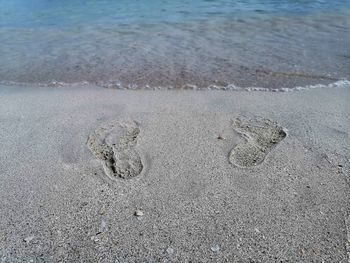 High angle view of footprints on beach