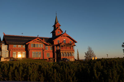 Scandic holmenkollen park hotel building exterior with sunlight reflecting on window. long shot.