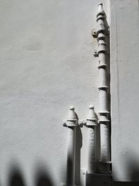 Low angle view of pipe on wall