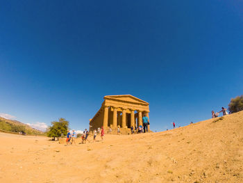 Low angle view of zeus temple  structure of valley of temples against clear blue sky