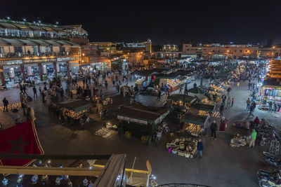 Crowd at illuminated night market in city