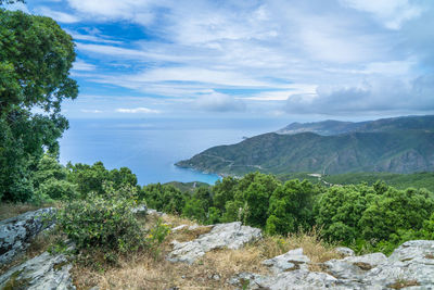 View of calm sea against mountain range