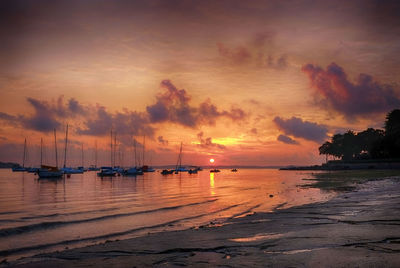 View of boats in sea at sunset