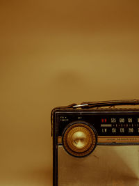 Vintage transistor radio with dial close up with brown background