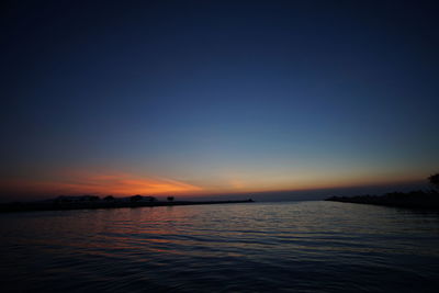 Scenic view of sea against clear sky during sunset