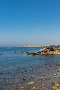 Scenic view of sea against clear blue sky