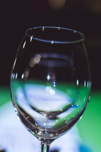 Close-up of wine glass against water