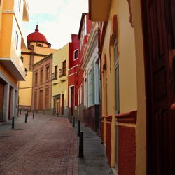 Empty alley amidst buildings in city