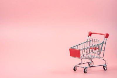 Close-up of crane against pink background