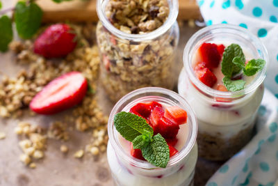 Homemade healthy breakfast with homemade baked granola, fresh strawberry and yogurt. 