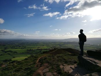 Man standing on landscape against sky