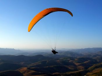 Hot air balloon flying over mountains