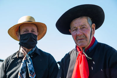 Portrait of senior men wearing hat against sky