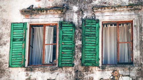 Low angle view of windows on old building