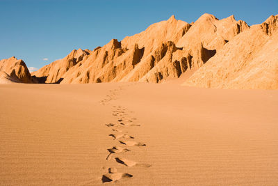 Scenic view of desert against clear sky